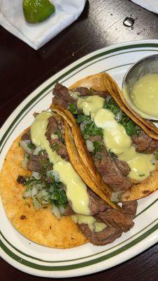 Steak tacos, cilantro and onion, corn tortilla, green sauce