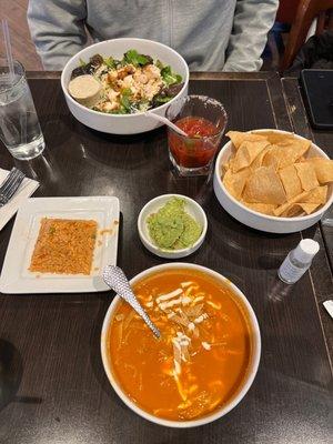 Caesar salad, chips and guacamole, chicken tortilla soup with a side of rice