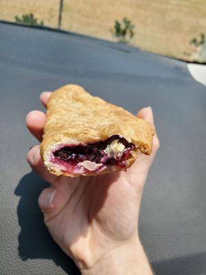 A half eaten blackberry fried pie