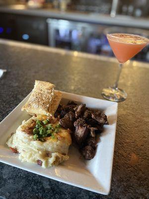 Steak bites, loaded mashed potatoes and my upside down pineapple martini after I stirred it up