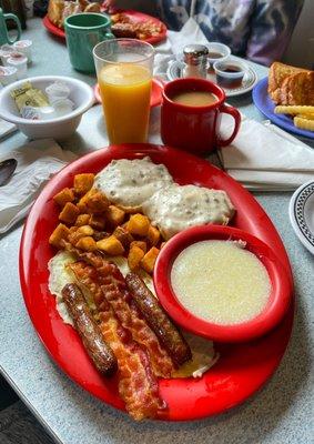 Dinermite Country; 2 eggs hiding under bacon & sausage, grits, country potatoes and a biscuit with sausage gravy. Yum yum!