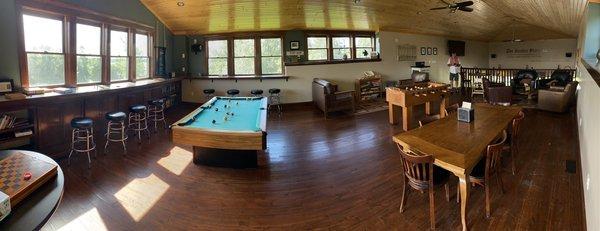 Upstairs loft with pool table, foosball table, and chairs to lounge