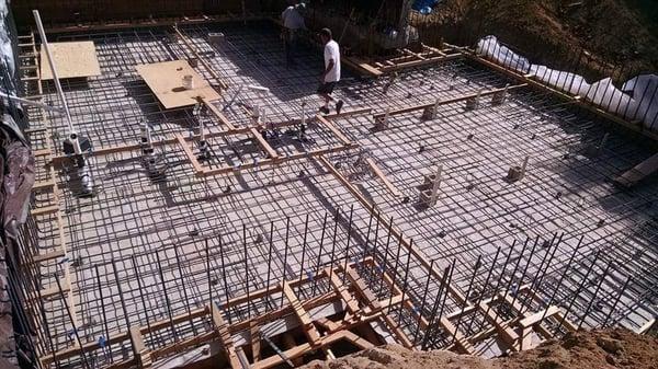 Del Mar basement .   Under slab waterproofing drainage system with reinforcements for exposed architectual interior walls.