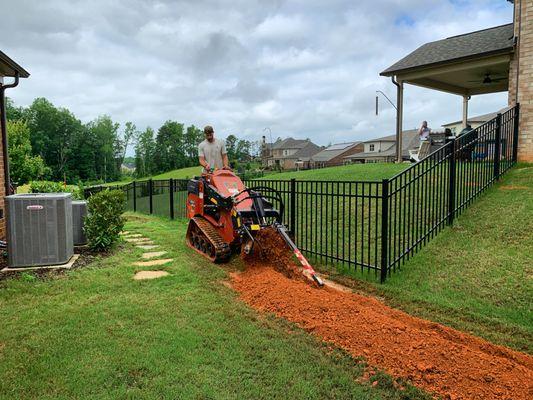 Routing downspouts into a French drain, which will route water right out of the yard.