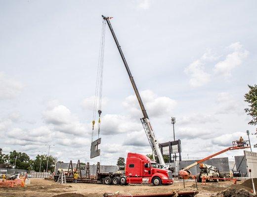 Our crane lifting a Precast Panel off our semi.  Howard Wood Field.