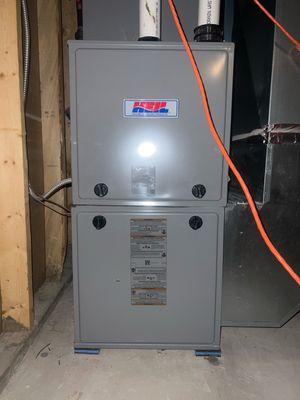 Exterior view of a Heil furnace during a furnace tune-up in Janesville, WI.