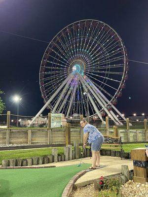 On the course with the giant Ferris wheel backdrop.