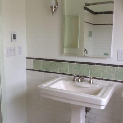 Sink area, controls on the wall are for lights, fan and heated flooring.