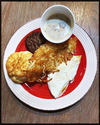 2 egg over easy with heavenly biscuit & sausage gravy, sausage Pattie's, crispy hash brown.