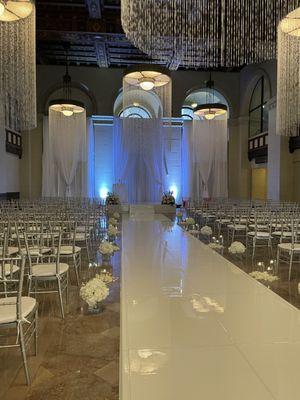 Ceremony Design including our Seamless Aisle Runner, Drapes, Lighting & Chairs