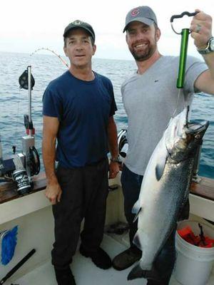 Capt john with happy customer with a nice king salmon.