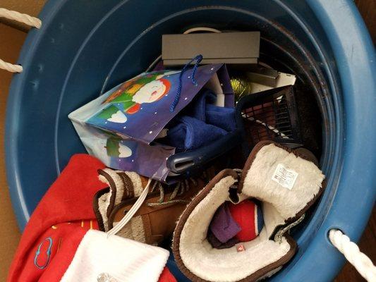 Random items stuffed carelessly into shoes & an a dirty outdoor plastic bin they found