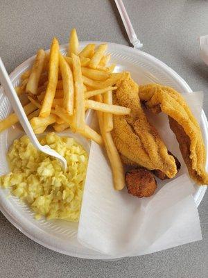 Fried catfish played with two hush puppies, coleslaw, French fries.