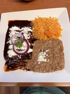 Chicken mole enchiladas with rice and beans