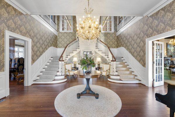 Grand foyer with embracing arms staircase.