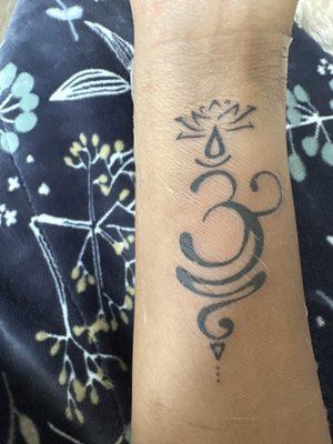 Lotus with Om, meditation pose and implies "breath"