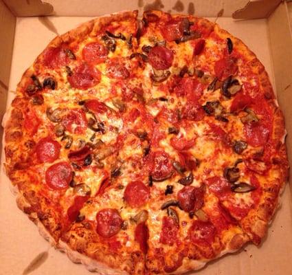 Large pepperoni and mushroom pizza.