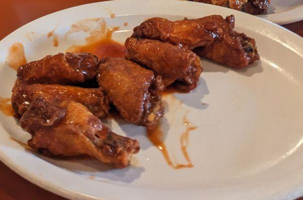 Chicken wings in Frank's hot sauce. The plate had a few more wings and a side of celery.