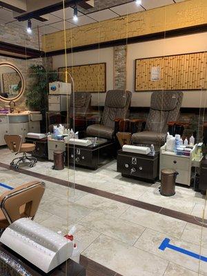 Pedicure area. Hard to see, but yellow strings are holding plexiglass dividers in front of each chair.