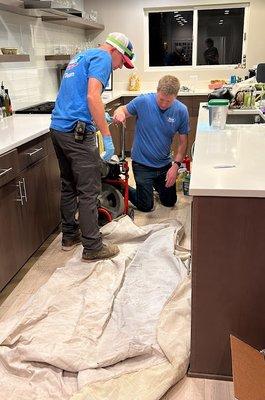 2 of our Plumbing Technicians unclogging a kitchen sink