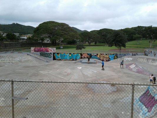 Wide open skate course. Baseball diamond behind it.