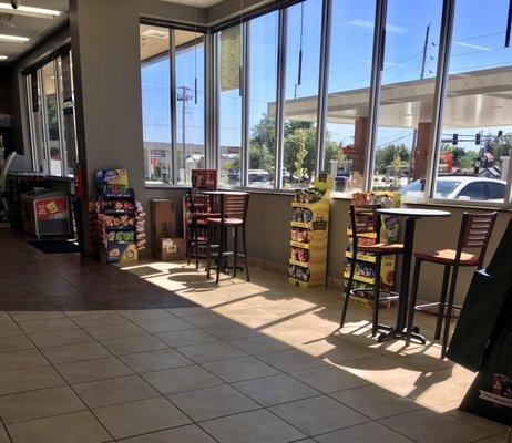 An airy dining area fronts the store.