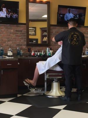 Rafael cutting the kid's hair.