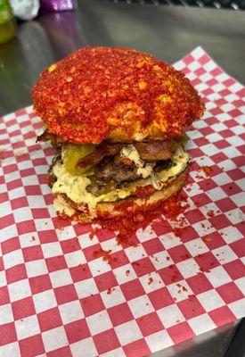 Hot Cheeto burger 
Double Cheeseburger, American cheese, crispy bacon, lettuce, pickles, hot Cheeto coated buns, our special lab sauce