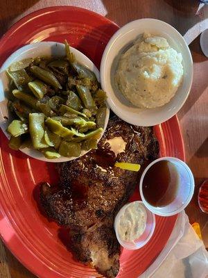 Prime rib roast with green beans and mashed potatoes.