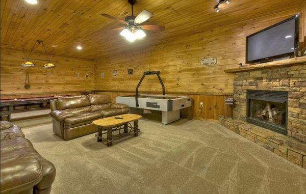 gameroom on lower level with tv and gas fireplace