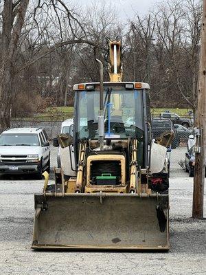 Here is the muffler mounted externally on the backhoe