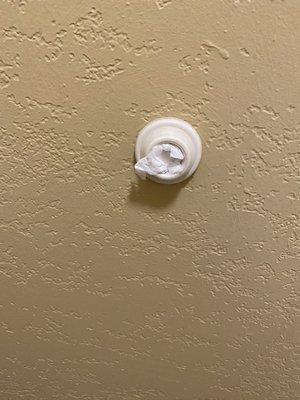 Toilet paper wedged in the door stopper