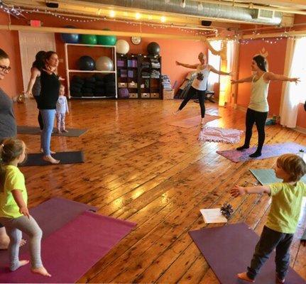 Family Yoga at Banyan Tree Yoga's beautiful studio. So much room.  Beautiful mill floors. Lots of props to play with!