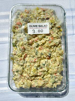 Olivie Salad (Potatoe Salad) with carrots herbs and mayonnaise.