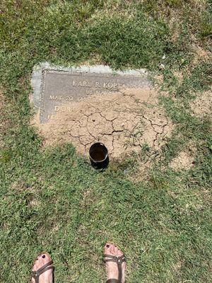 Grave marker left with dirt thrown on it for weeks.