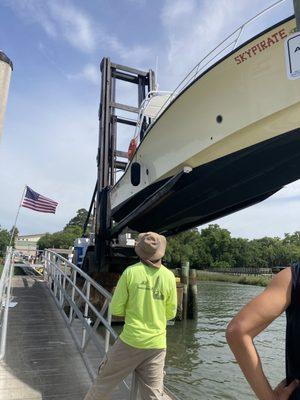 Huge boat forklift lowering the parasailing boat into the water