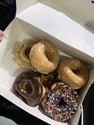 Old fashioned donut, 2 glazed, chocolate glazed and chocolate sprinkled and an Apple fritter