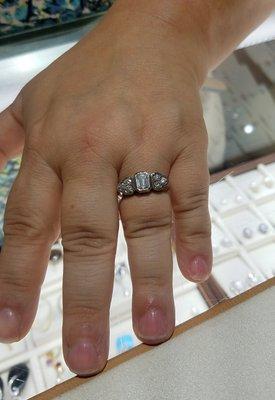 Custom Made Ring 
 Using Customers Diamonds we made a
 14K White Gold Ring w/ Emerald Cut Center Stone & 3 stones on each side.  LOVED IT!