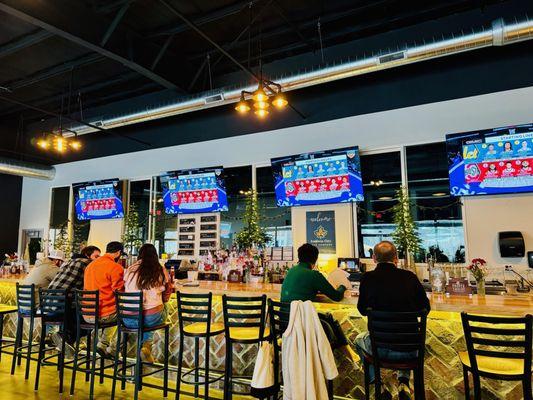 Plenty of TVs with sports behind the bar.  An incredibly long bar with dozens of seats.  Bright, open space with high ceilings.