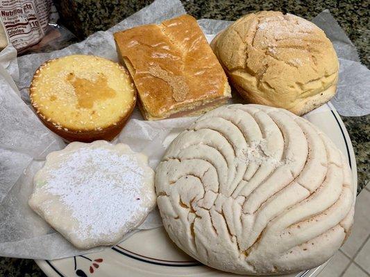 Clockwise from top: corn cake with pink gelatin filling, concha-ish variation, vanilla concha, polvorone cookie, quesadilla salvadoreña