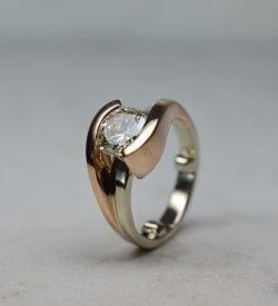 Two tone rose gold and white gold round diamond engagement ring.