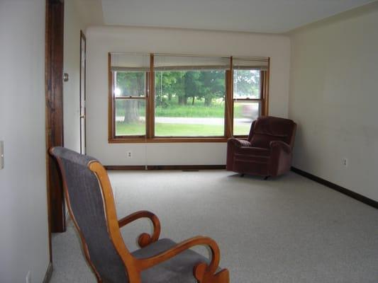 Large picture window lets in lots of light in this large living room.