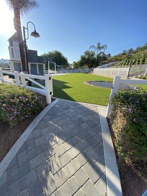 Paver entry way to some beautiful artificial grass