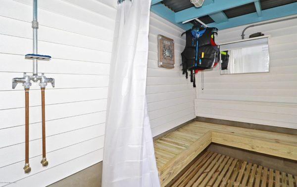 An outdoor shower is a must have for living along the shore!