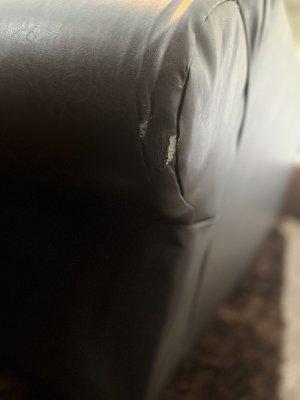 Second tear on the leather arm of the couch.