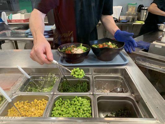 7/26/23 He's carefully & systematically creating my poke bowl