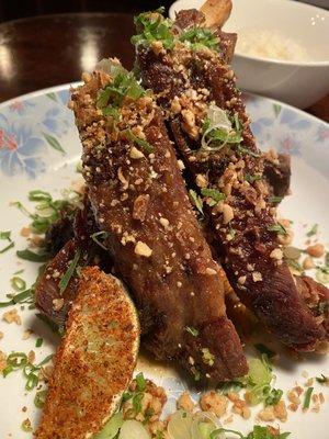 Braised and fried ribs tossed in burnt honey and Sichuan spices, topped with peanuts, bonito and cilantro