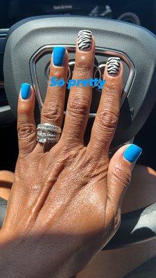 Pretty blue nails with zebra designs.