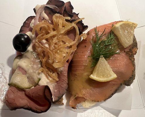 Left - roast beef , crispy onions, house made pickles , olives and horseradish Right - fresh cold- smoked salmon with dill