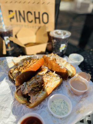 Pincho  dog! Topped with applewood-smoked , pinnaple bits, cilantro, pickles, onions, crispy fries, fresh brioche bread